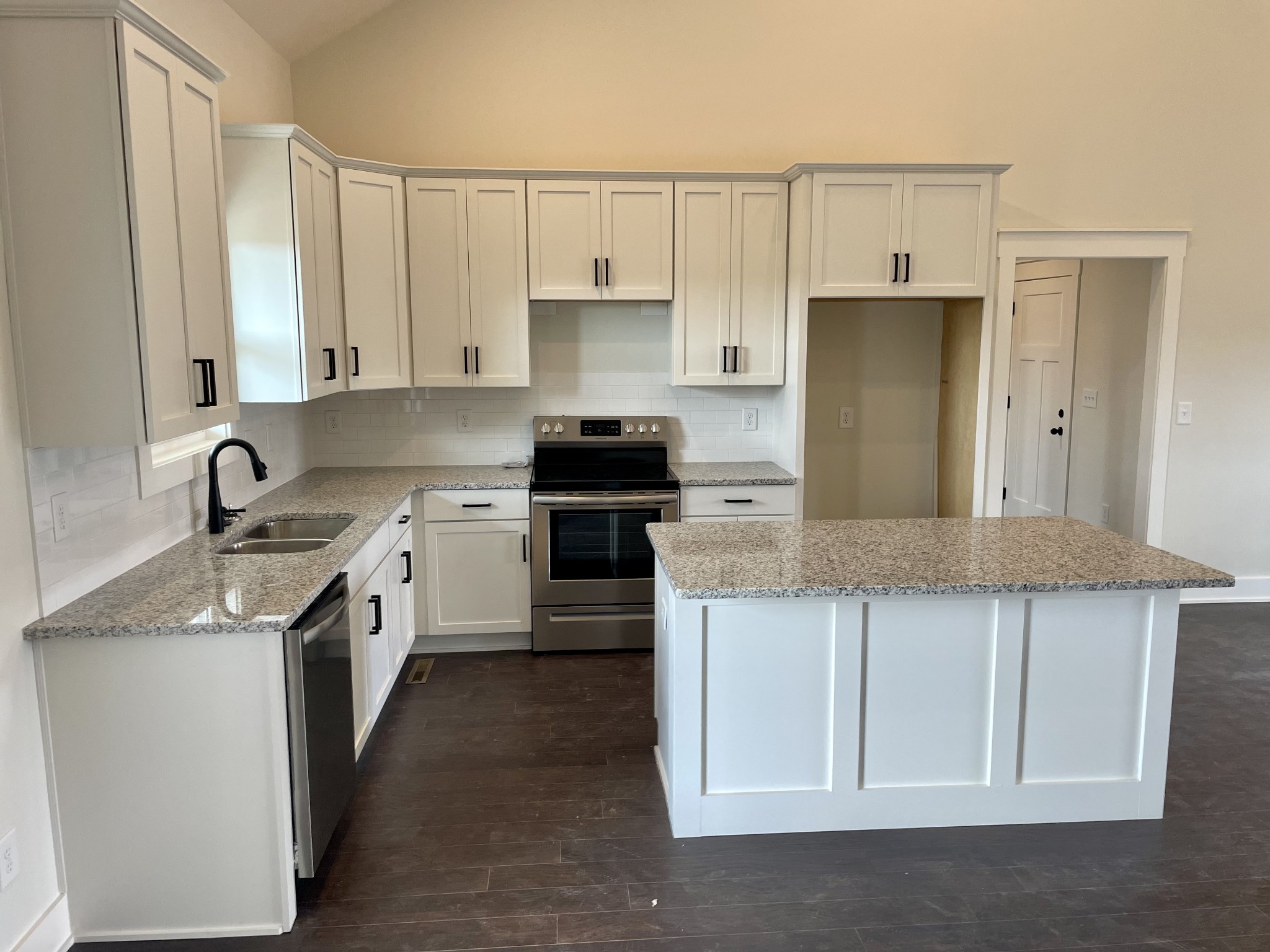 249 Tom Ferrell Road Portland, TN 37148 - Photo 13 of 28 a kitchen with stainless steel appliances granite countertop a stove a sink and a refrigerator