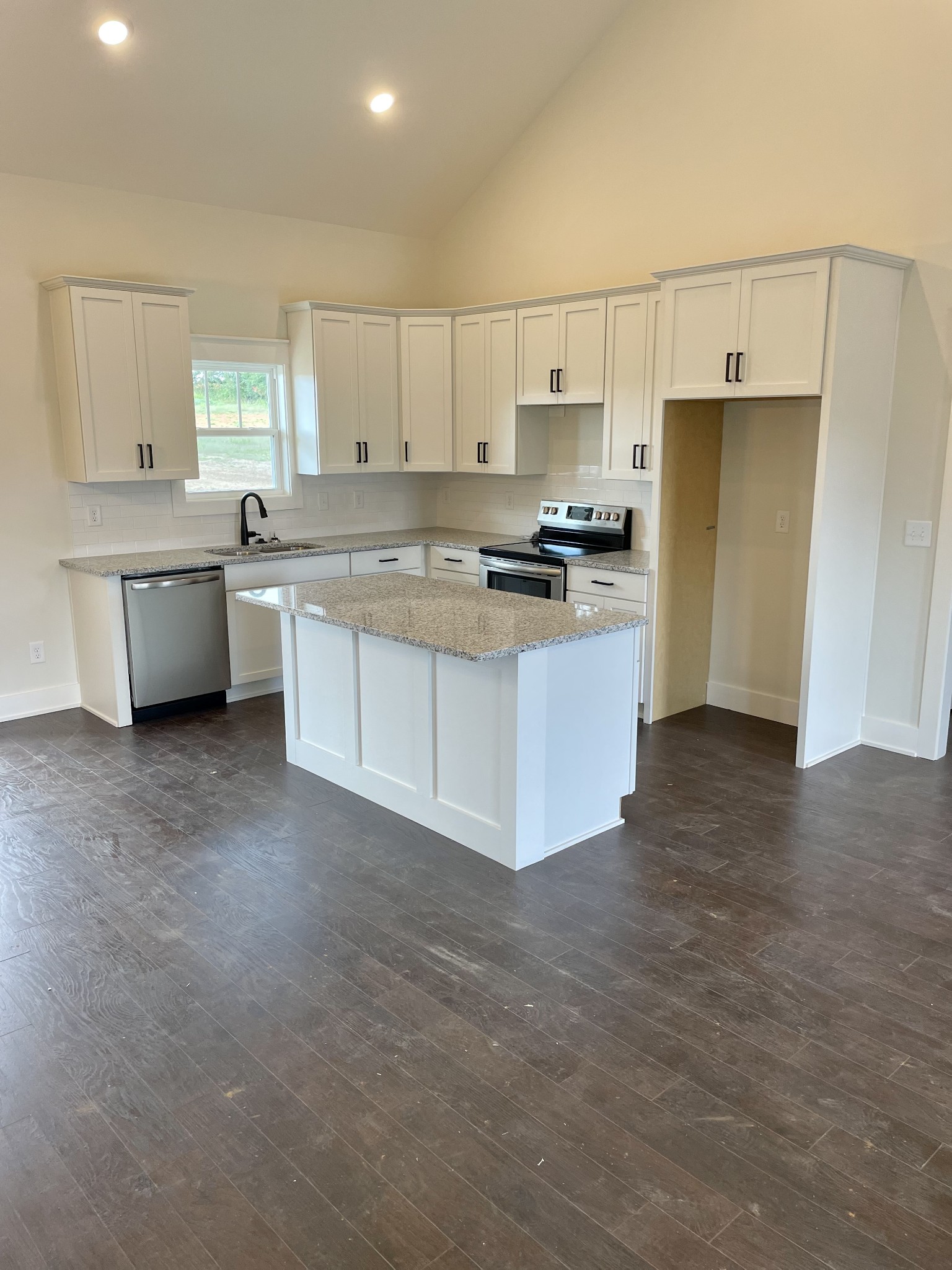 249 Tom Ferrell Road Portland, TN 37148 - Photo 14 of 28 a kitchen with stainless steel appliances a white stove top oven cabinets a sink and a refrigerator