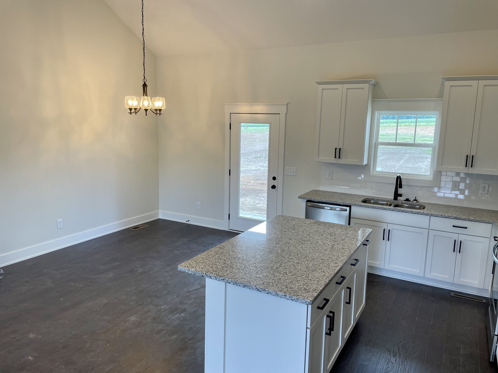 249 Tom Ferrell Road Portland, TN 37148 - Photo 15 of 28 a kitchen with a stove a sink a center island and cabinets