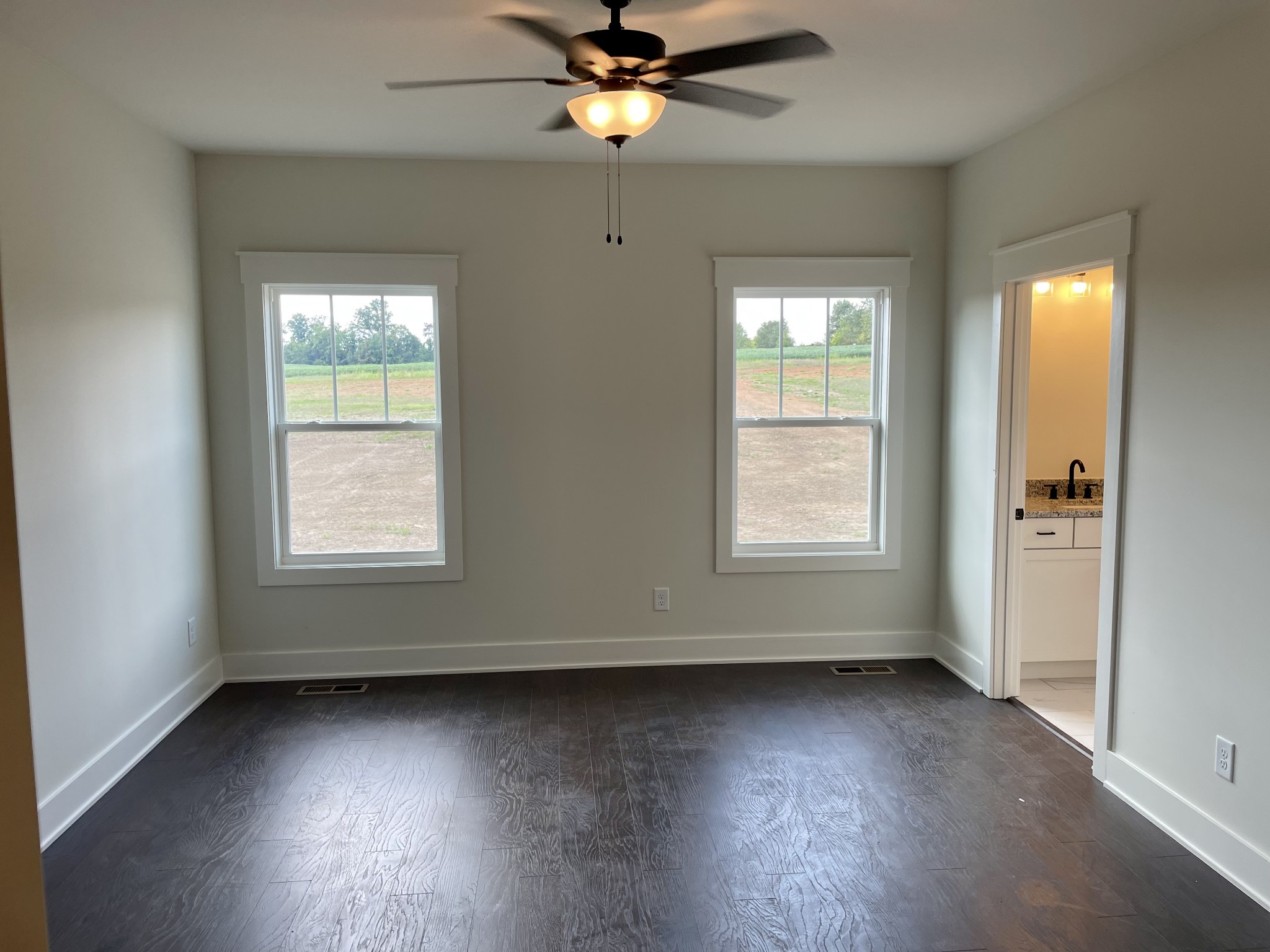 249 Tom Ferrell Road Portland, TN 37148 - Photo 17 of 28 an empty room with wooden floor and windows