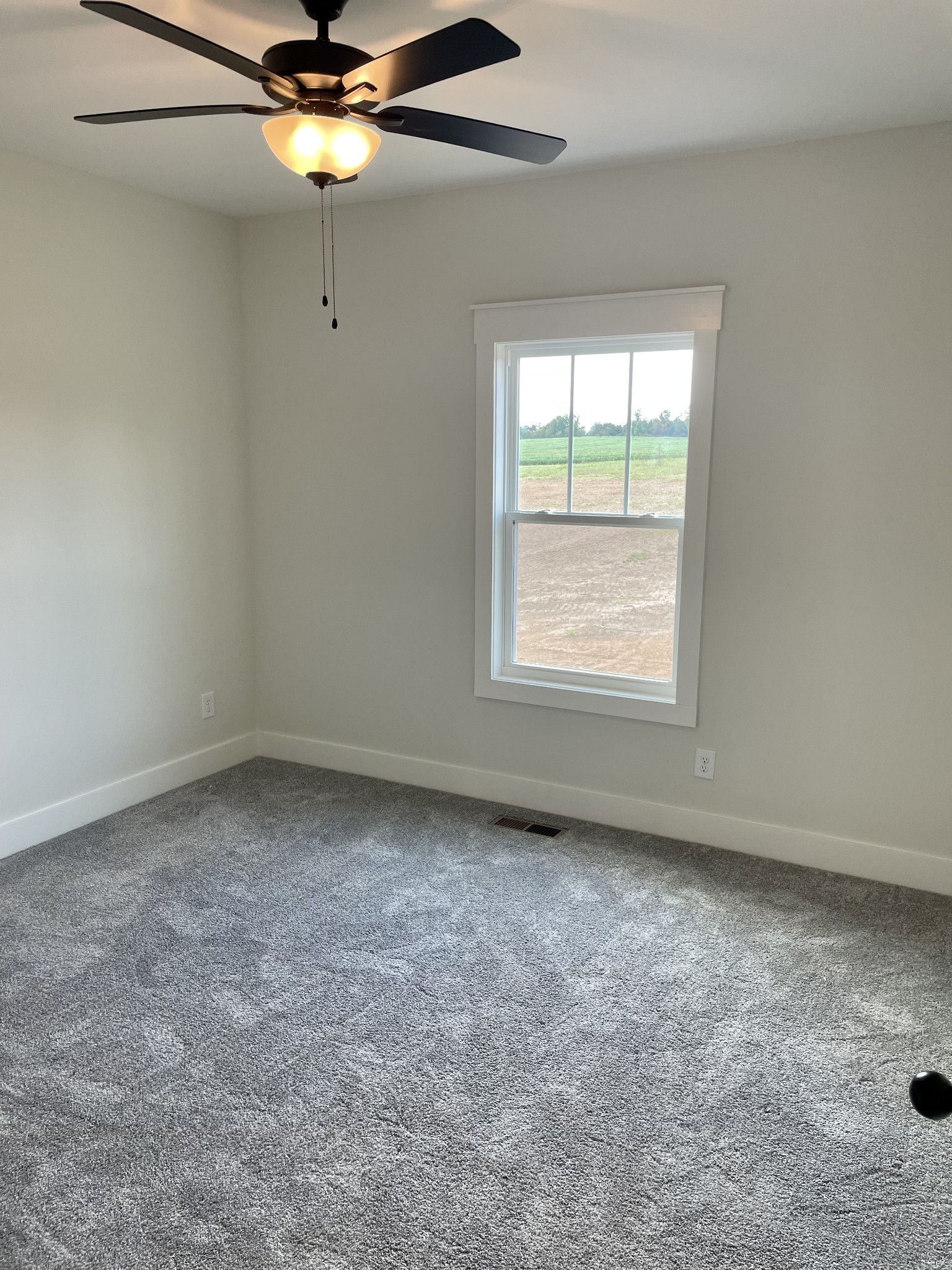 249 Tom Ferrell Road Portland, TN 37148 - Photo 21 of 28 an empty room with a window and a fan