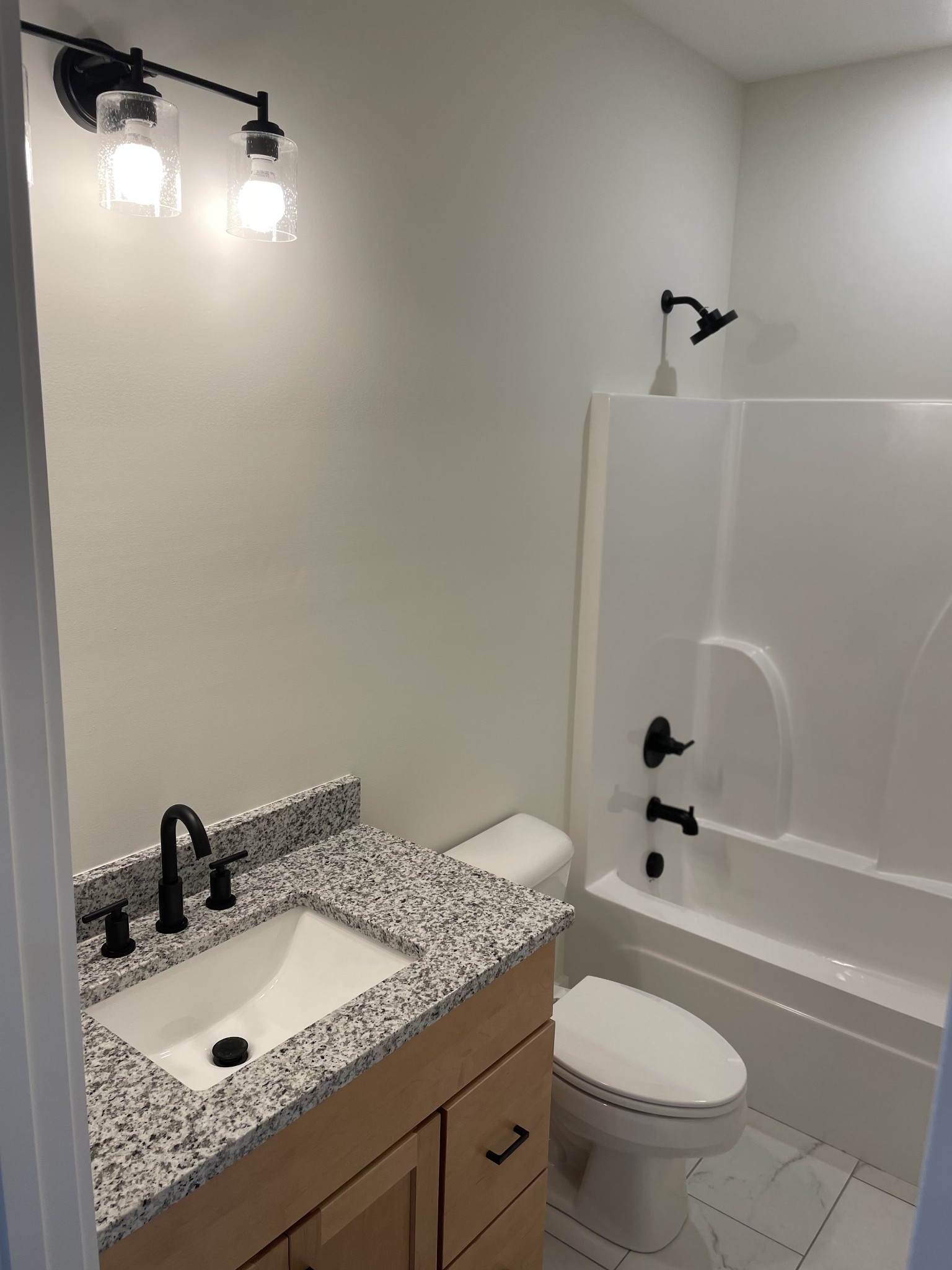 249 Tom Ferrell Road Portland, TN 37148 - Photo 23 of 28 a bathroom with a granite countertop sink toilet and shower