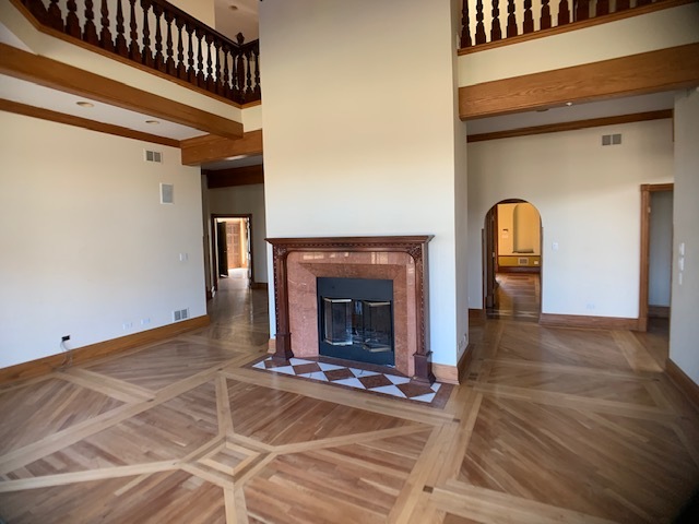 220 Bradwell Road Inverness, IL 60010 - Photo 11 of 20 a view of a livingroom with wooden floor a fireplace and entryway