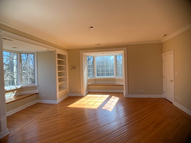 220 Bradwell Road Inverness, IL 60010 - Photo 20 of 20 a view of an empty room with wooden floor and a window