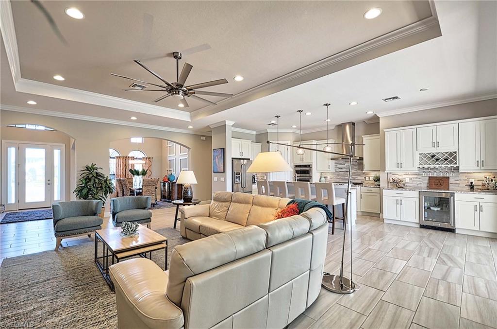 2166 Antigua Lane Naples, FL 34120 - Photo 12 of 35 a living room with furniture a ceiling fan and a rug