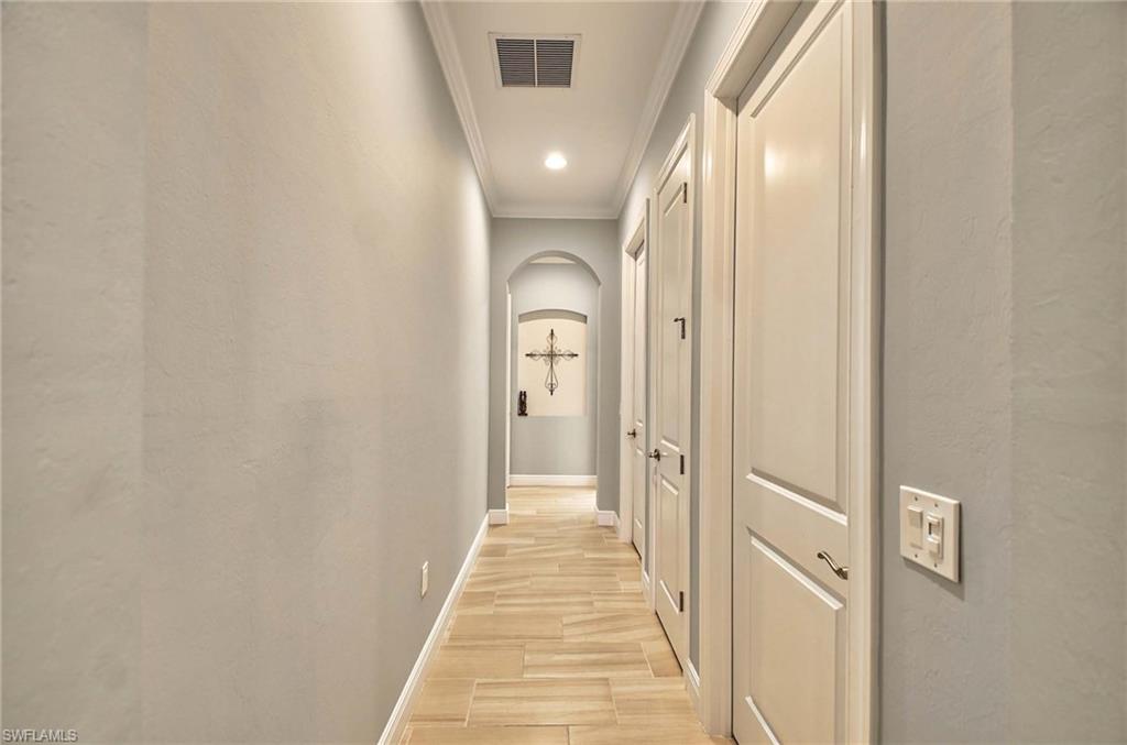 2166 Antigua Lane Naples, FL 34120 - Photo 13 of 35 a view of a hallway with wooden floor and a bathroom