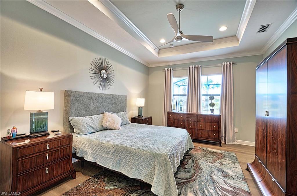 2166 Antigua Lane Naples, FL 34120 - Photo 14 of 35 a bedroom with a large bed and a window