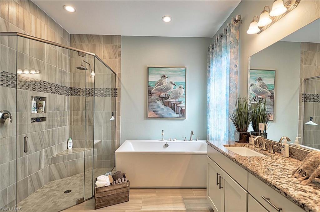 2166 Antigua Lane Naples, FL 34120 - Photo 16 of 35 a bathroom with a double vanity sink mirror double and shower