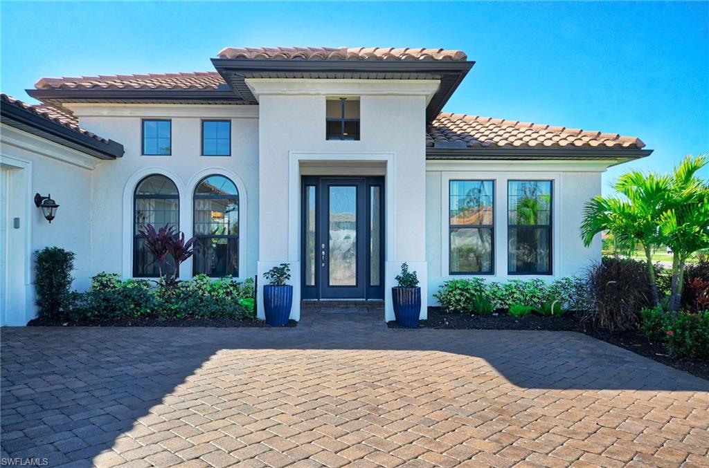 2166 Antigua Lane Naples, FL 34120 - Photo 2 of 35 a front view of a house with garden