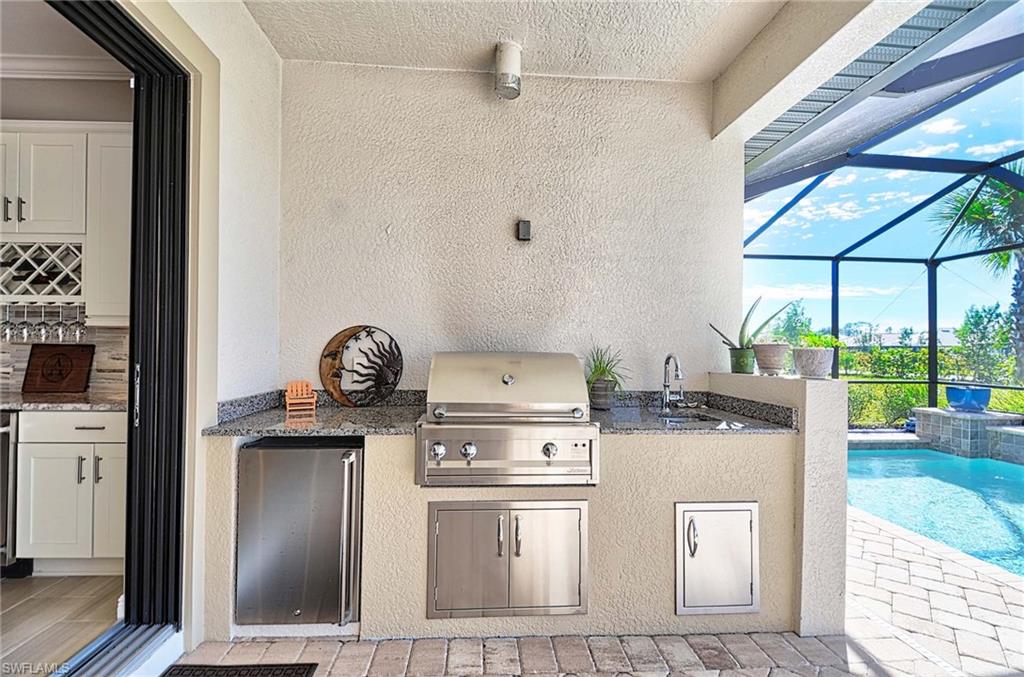 2166 Antigua Lane Naples, FL 34120 - Photo 22 of 35 a stove top oven sitting inside of a kitchen