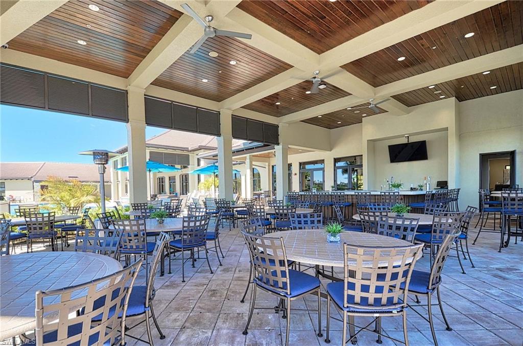 2166 Antigua Lane Naples, FL 34120 - Photo 30 of 35 a view of a dining room with furniture window and wooden floor