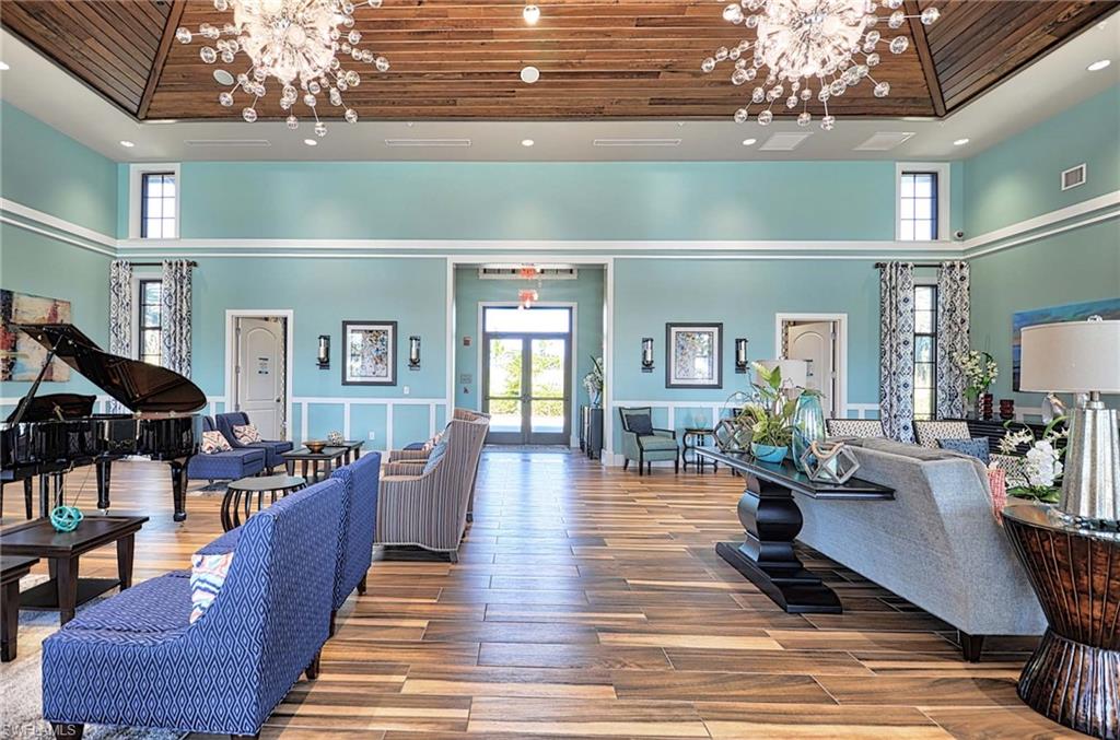 2166 Antigua Lane Naples, FL 34120 - Photo 31 of 35 a living room with furniture and a chandelier