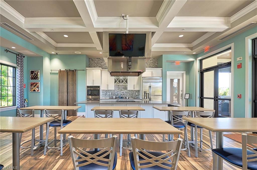 2166 Antigua Lane Naples, FL 34120 - Photo 32 of 35 a large kitchen with a table and chairs