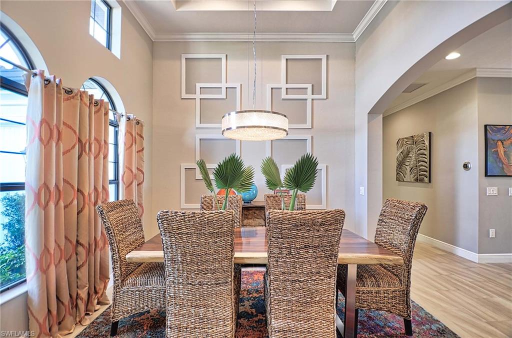 2166 Antigua Lane Naples, FL 34120 - Photo 6 of 35 a view of a dining room with furniture window and wooden floor