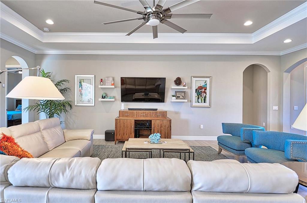 2166 Antigua Lane Naples, FL 34120 - Photo 10 of 35 a living room with furniture and a flat screen tv