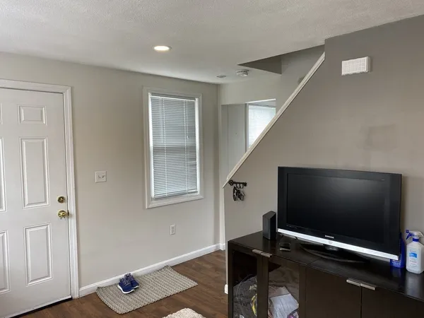 a room with gym equipment and a flat screen tv