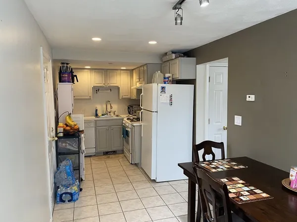 a kitchen with a refrigerator and a stove top oven