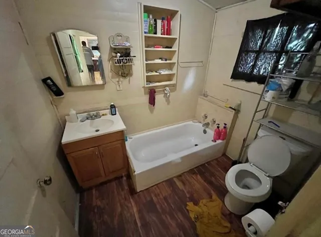 a bathroom with a toilet sink and mirror