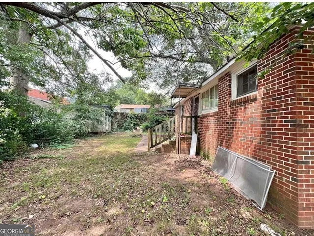 a view of house with backyard