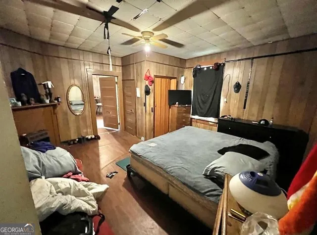 a bed room with furniture and a flat screen tv