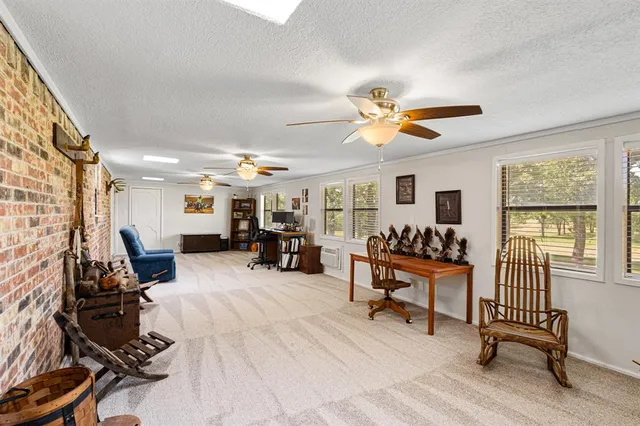 a bedroom with furniture and a large window