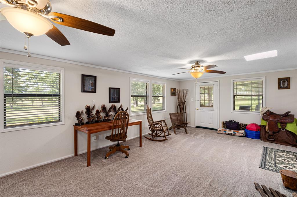 818 Country Club Road Bowie, TX 76230 - Photo 13 of 34 a livingroom with workspace a window and a couch