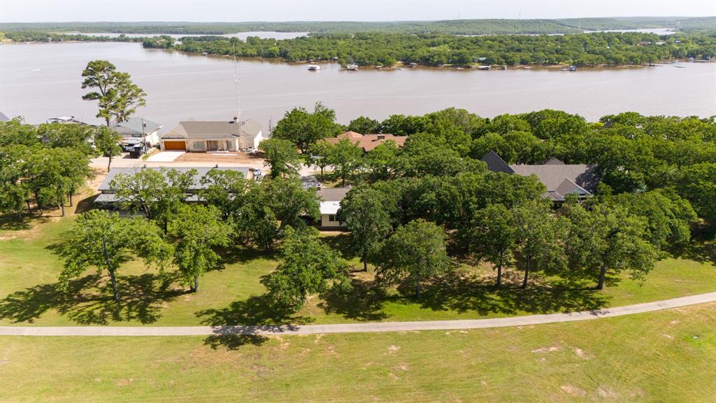 818 Country Club Road Bowie, TX 76230 - Photo 33 of 34 an aerial view of a residential houses with lake view