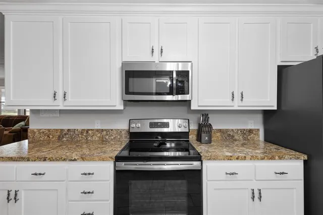 a stove top oven sitting inside of a kitchen