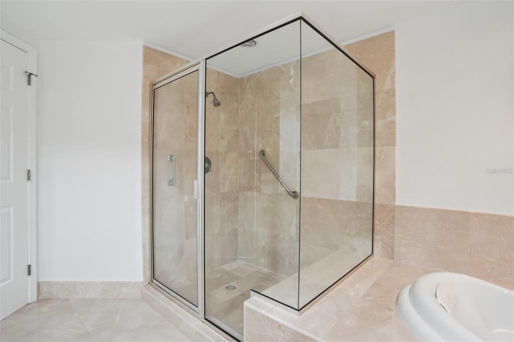 231 Riverside Drive, Unit 8071 Daytona Beach, FL 32117 - Photo 22 of 33 a bathroom that has a glass shower door