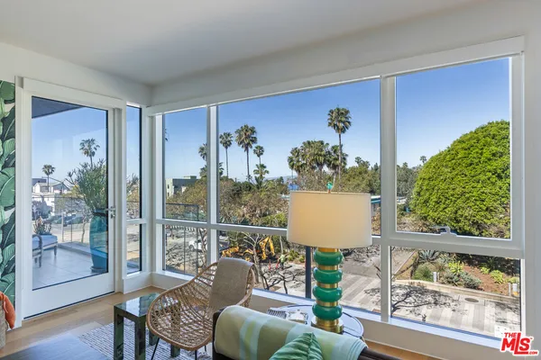 a view of a living room with a large window and floor to ceiling window