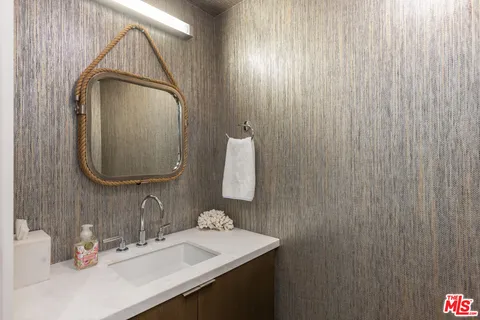 a bathroom with a sink a vanity and a mirror
