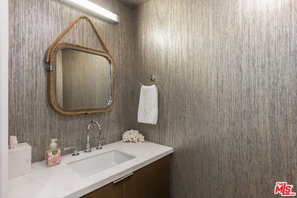 a bathroom with a sink a vanity and a mirror
