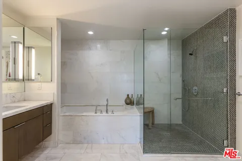 a bathroom with a double vanity sink mirror and shower