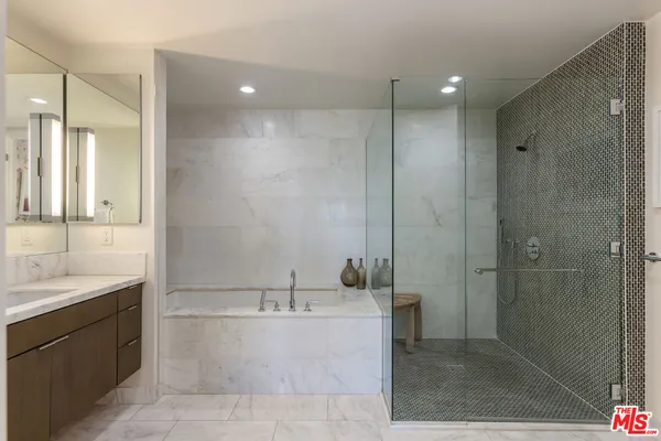 a bathroom with a double vanity sink mirror and shower
