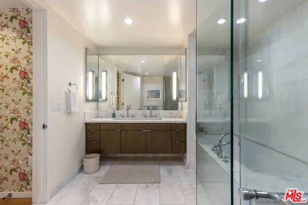 a bathroom with a granite countertop sink mirror and shower