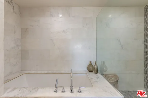 a bathroom with a sink and shower