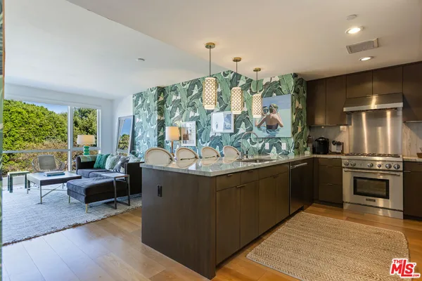 a kitchen with stainless steel appliances granite countertop a stove and cabinets