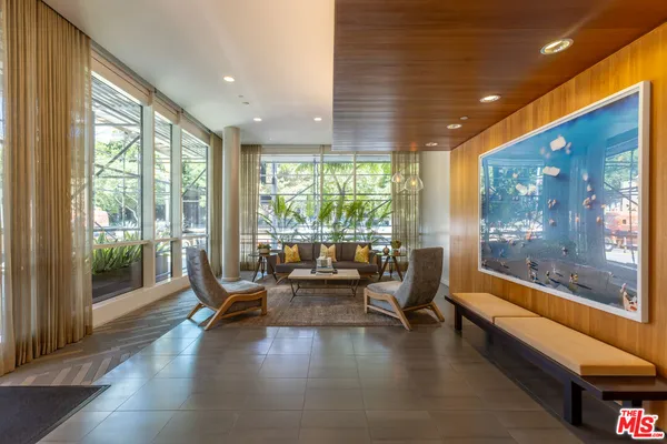 a lobby with furniture and floor to ceiling window