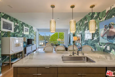 a kitchen with a faucet a sink and a wooden floor