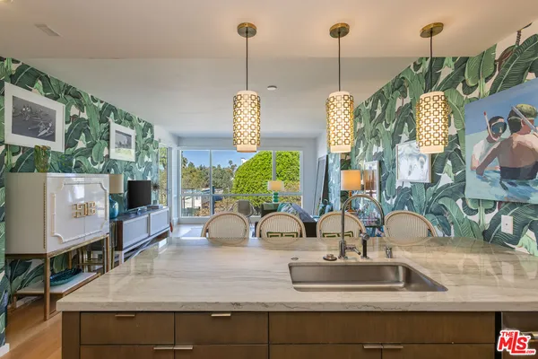 a kitchen with a faucet a sink and a wooden floor