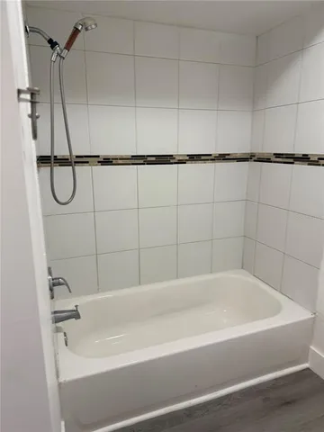a bathroom with a shower and a bath tub