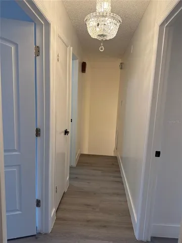 a view of a hallway with wooden floor