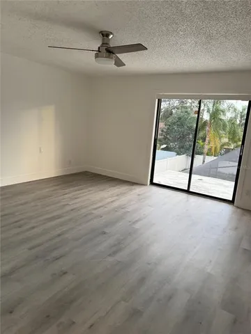 a view of a livingroom with an empty space and a balcony