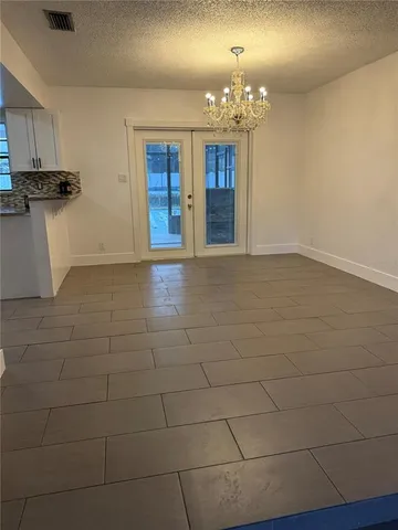 a view of a kitchen with a sink and cabinets