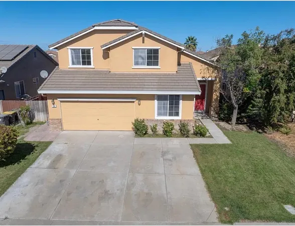 a front view of a house with yard