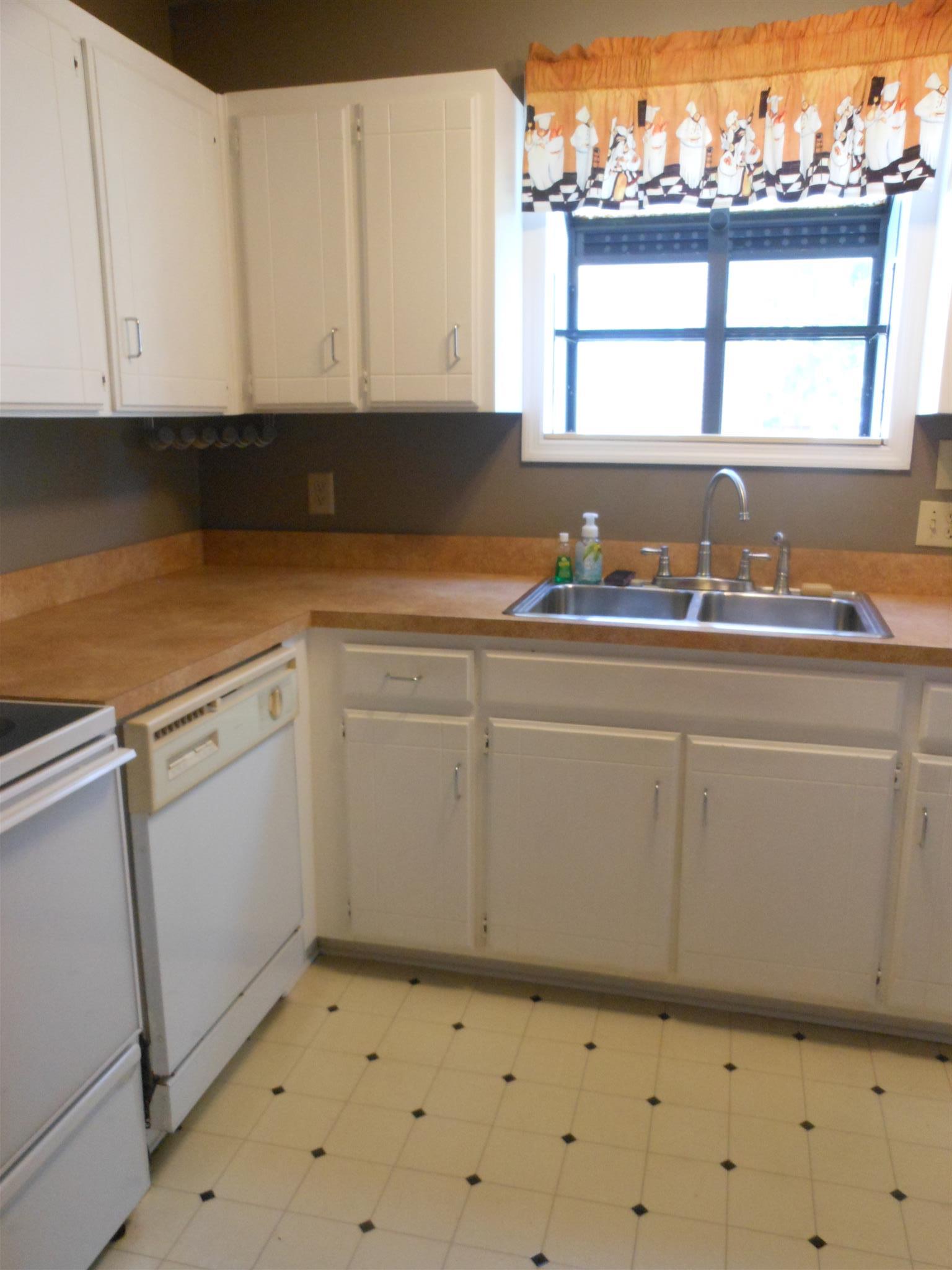 3244 B Anderson Road Antioch, TN 37013 - Photo 8 of 9 a kitchen with granite countertop white cabinets and window