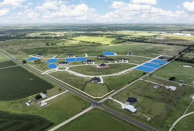 a view of a pool with a table and chairs in the terrace