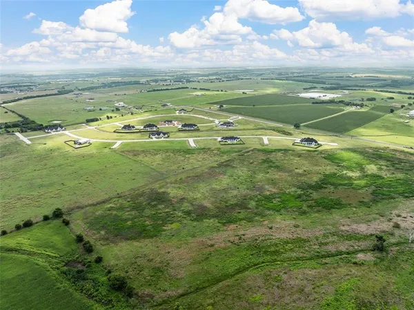 a view of a field with an ocean
