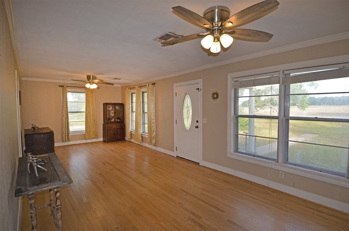 2352 Airport Road Brenham, TX 77833 - Photo 8 of 24 a view of an empty room with window closet area and chandelier fan