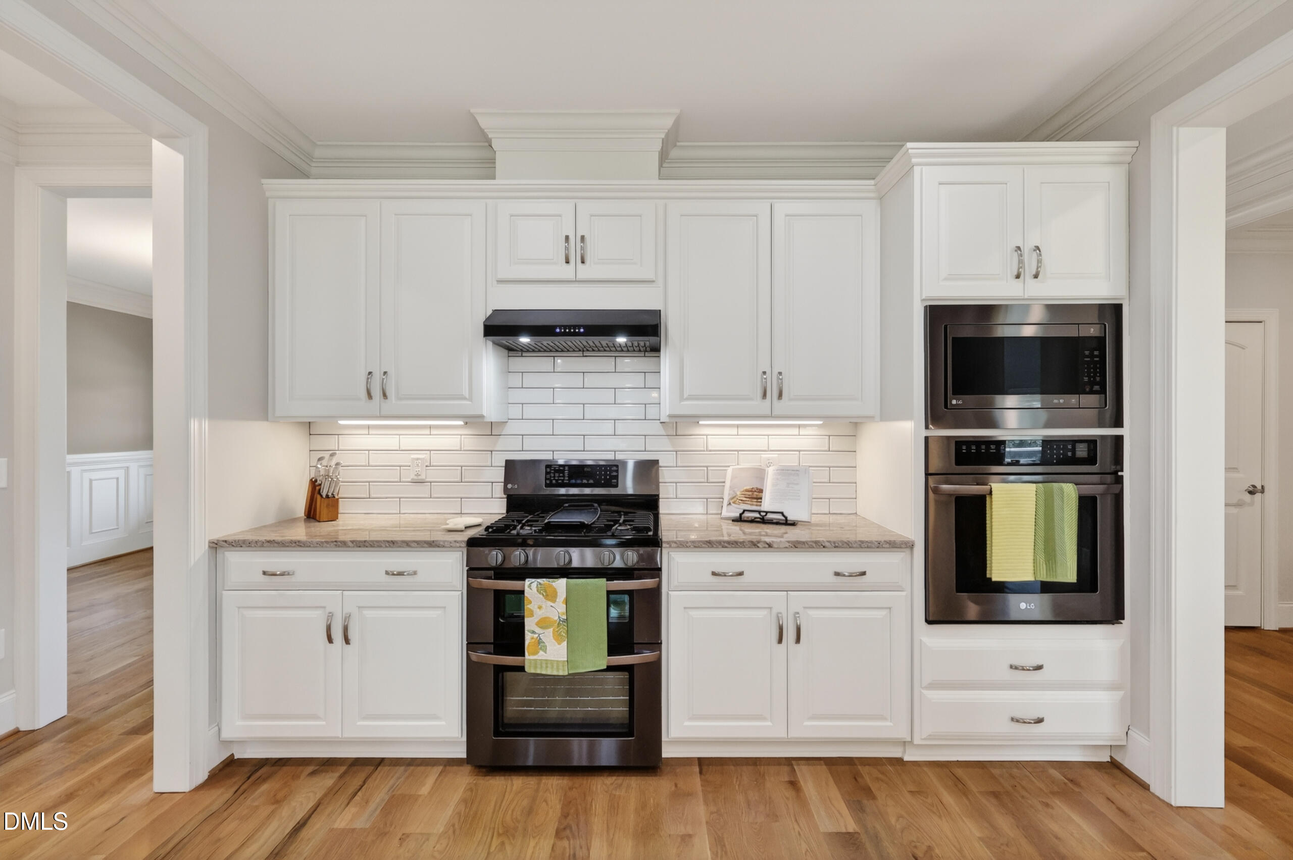 261 Character Drive Rolesville, NC 27571 - Photo 21 of 77 a kitchen with white cabinets and stainless steel appliances